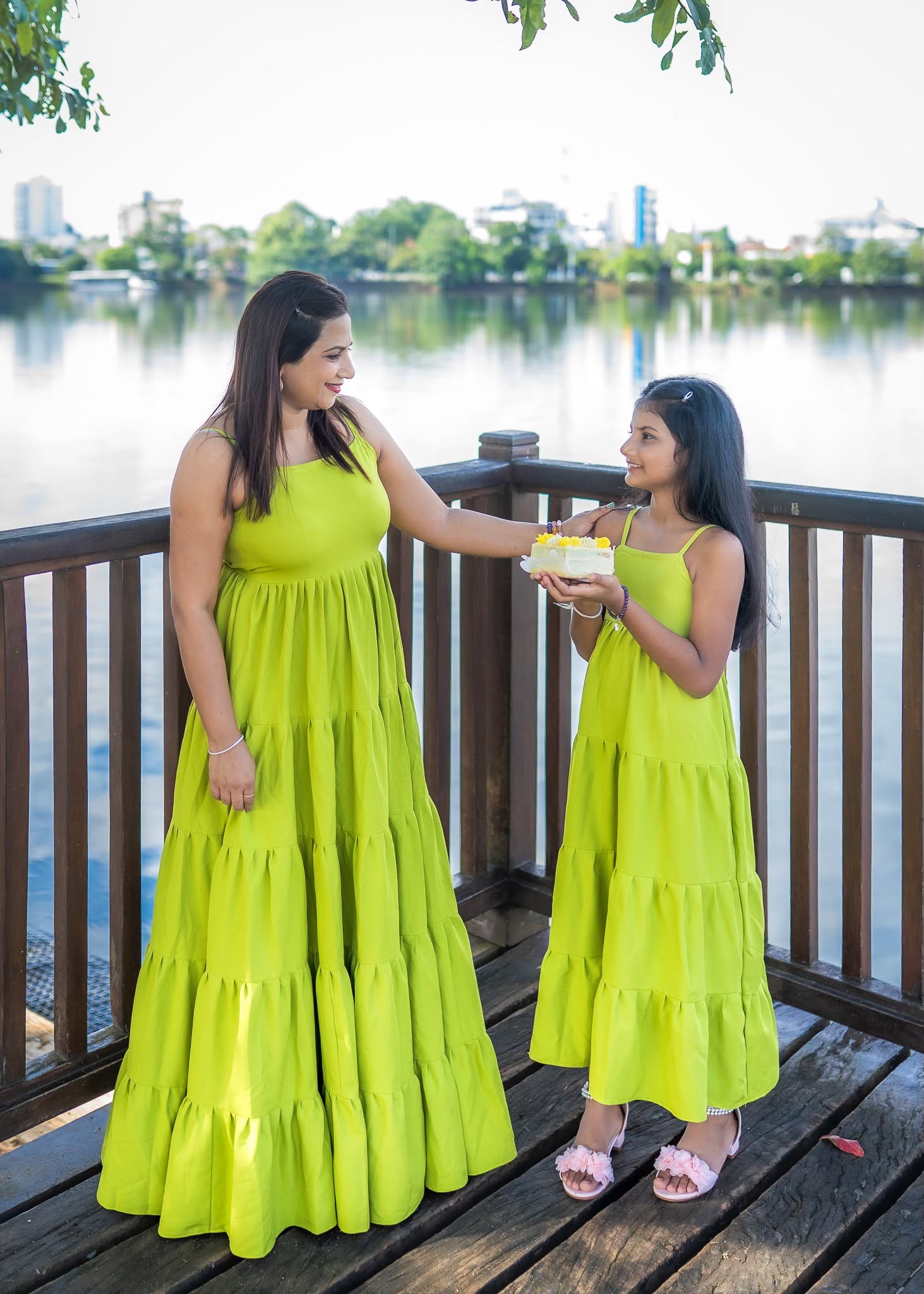 Mother and daughter birthday photoshoot sharing birthday cake by a lake in Colombo, Sri Lanka