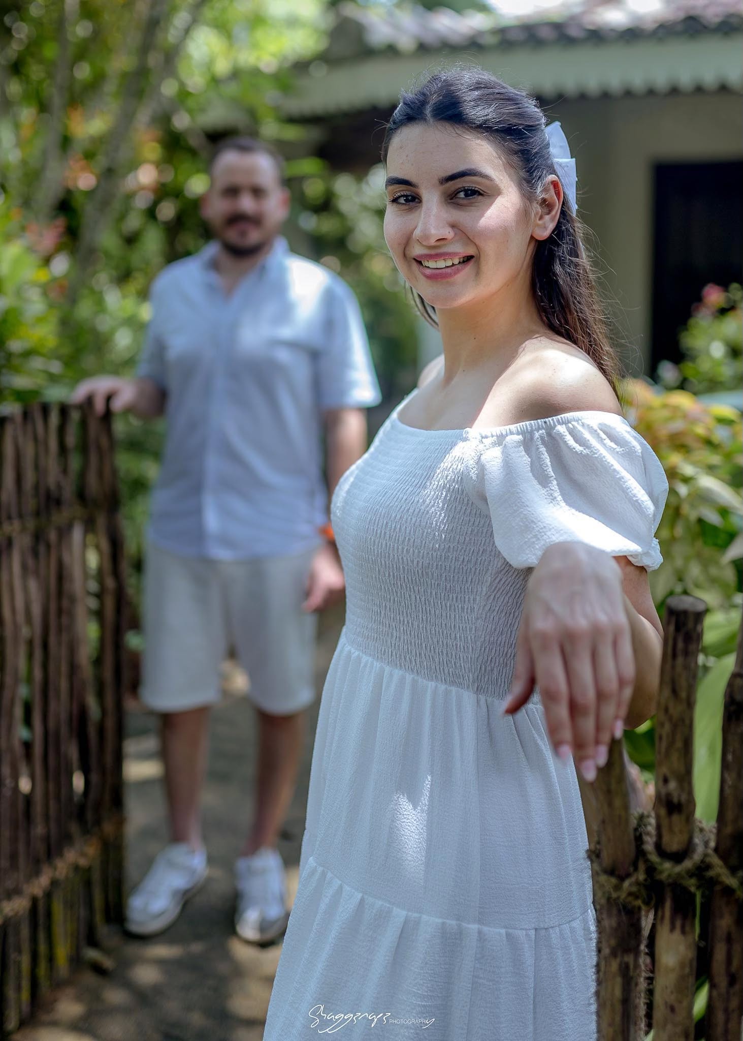 Couple portrait photoshoot by a garden fence in Colombo, Sri Lanka