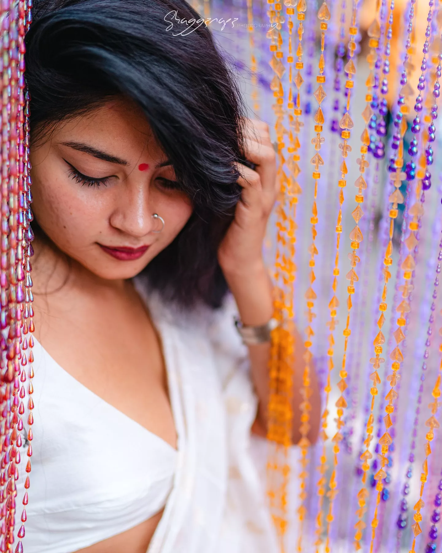 Desi fashion portrait photoshoot resting against a bead curtain, Colombo, Sri Lanka