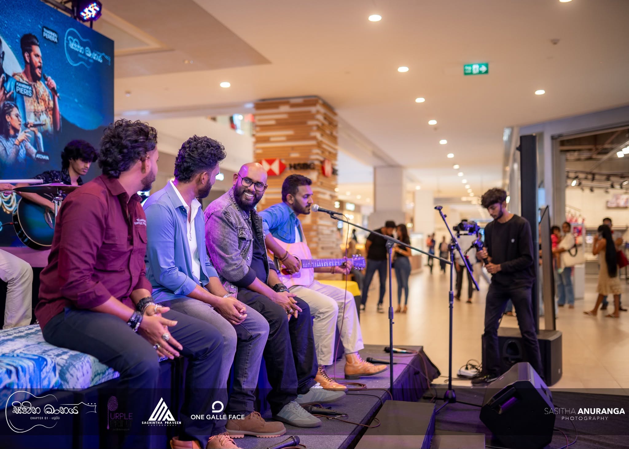 Event photography of musicians seated on stage at Sihina Maanaya, One Galle Face mall