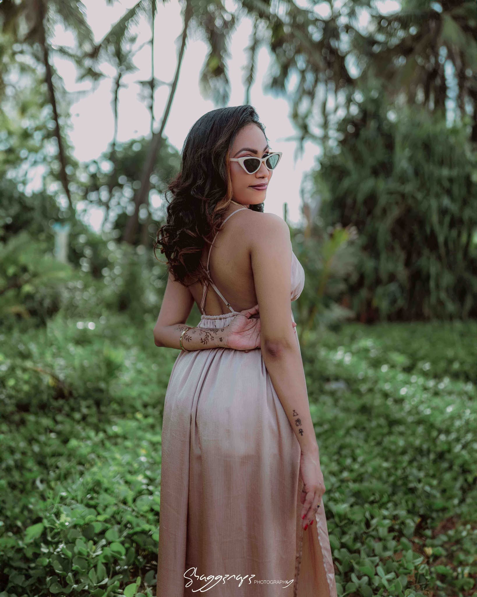 Commercial fashion photoshoot beside a palm tree on a Sri Lankan beach