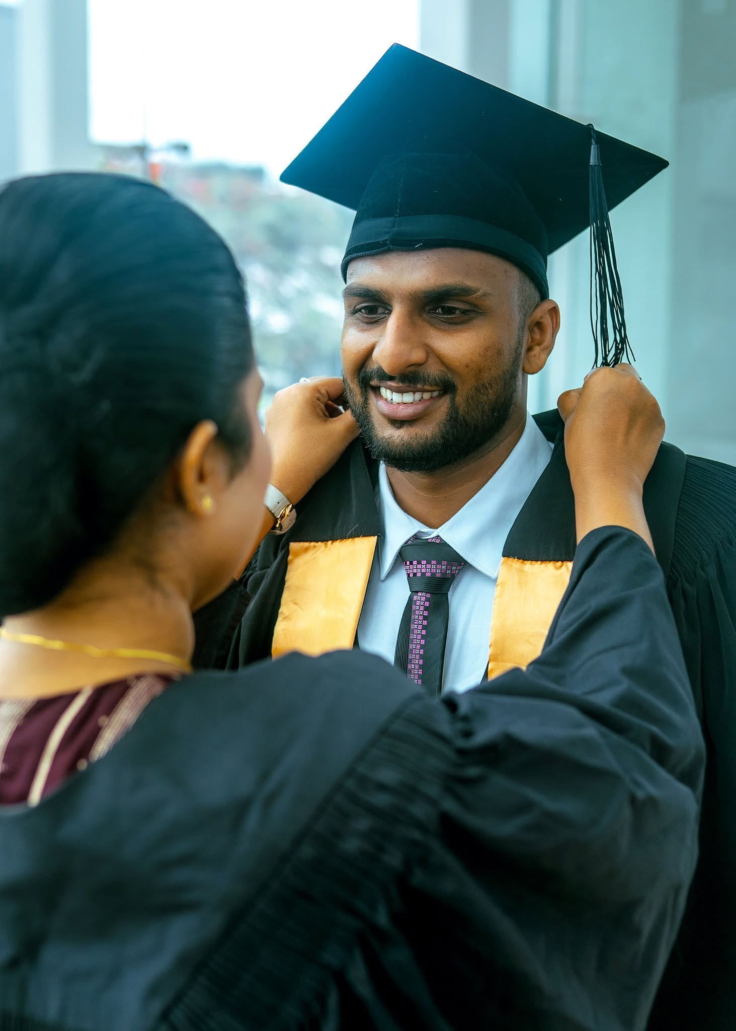 Graduation portrait photography moment with mother adjusting cap, Colombo, Sri Lanka
