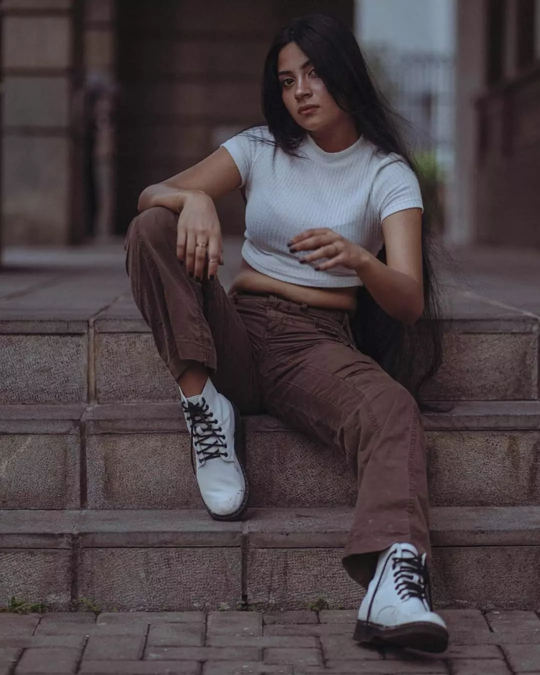 Street fashion photoshoot seated on stone steps in Colombo, Sri Lanka
